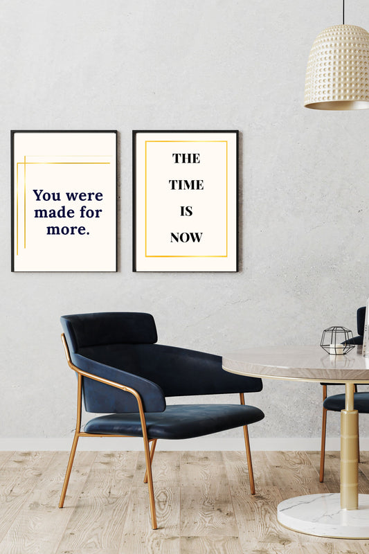 Motivational printable wall art set featuring "You were made for more." in navy text with gold accents and "THE TIME IS NOW" in bold black with a gold border, both styled in a modern dining space with navy chairs and gold details, creating an inspiring and sophisticated ambiance